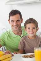 Portrait of father and son during breakfast