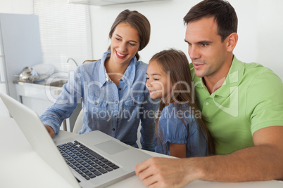 Family using a laptop pc in the kitchen