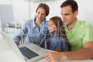 Family using a laptop pc in the kitchen