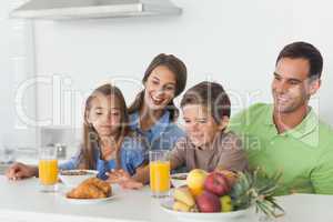 Parents having breakfast with children