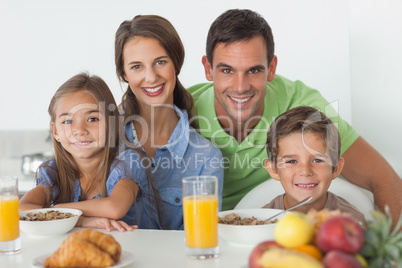 Portrait of parents having breakfast with their children