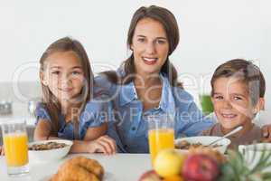 Mother having breakfast with her children