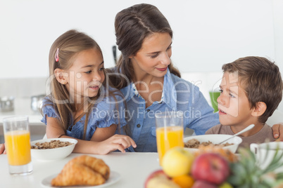 Pretty mother having breakfast with her children