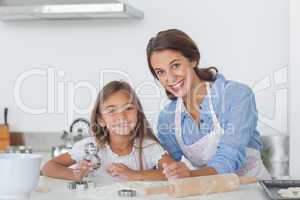 Portrait of mother and daughter baking together