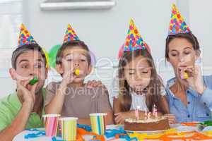 Family with party horn celebrating their daughter party