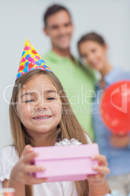 Little girl holding a birthday present