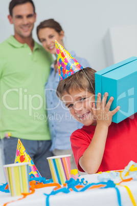 Little boy shaking his birthday gift