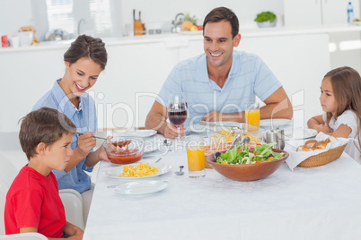 Family eating pasta and salad