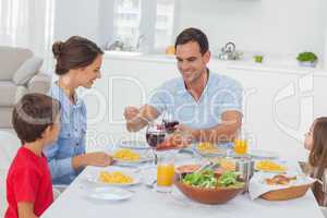 Man serving wife during the dinner