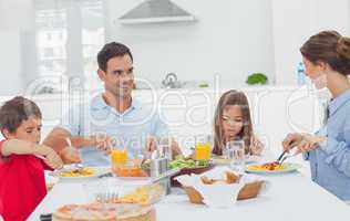 Family eating pasta with sauce