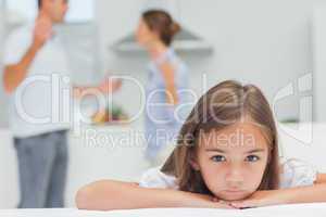 Upset girl listening to parents quarreling