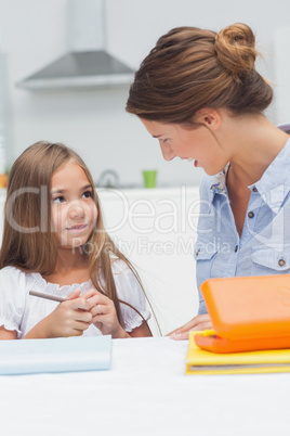 Mother chatting with her daughter drawing
