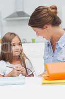 Mother chatting with her daughter drawing