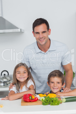 Portrait of a father and his children in the kitchen