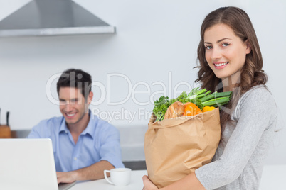 Woman holding groceries bag