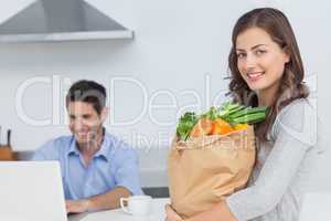 Woman holding groceries bag