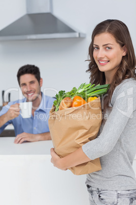 Attractive woman holding groceries bag
