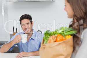 Pretty woman holding groceries bag