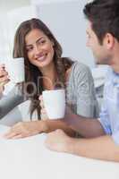 Cheerful couple drinking a cup of coffee
