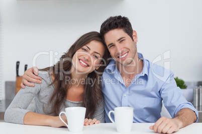 Couple embracing each other in the kitchen