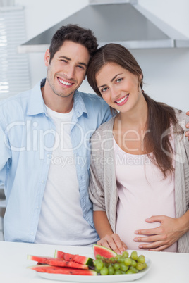 Pregnant woman and her husband standing together