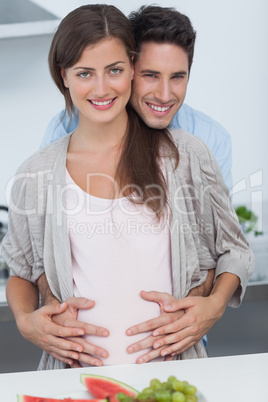 Man holding the belly of his pregnant wife