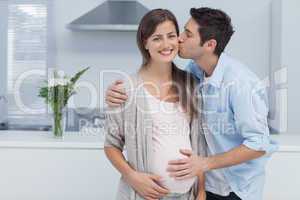 Man kissing his pregnant wife