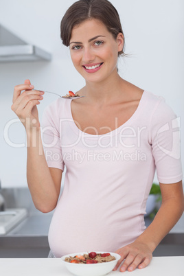 Pregnant woman eating a bowl of cereal