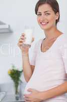 Pregnant woman drinking a glass of milk