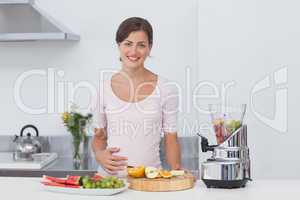 Pregnant woman making a fruit cocktail