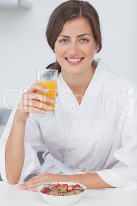 Woman holding a orange juice glass