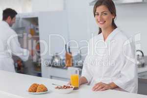Woman having breakfast with cereal and orange juice