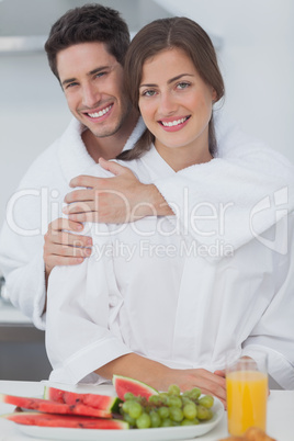 Man embracing his wife in the kitchen