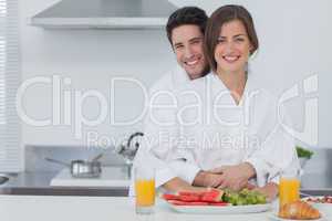 Portrait of a man embracing his wife in the kitchen