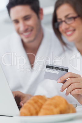 Cheerful couple purchasing online