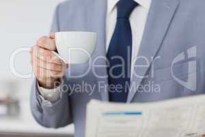 Businessman holding a cup of coffee