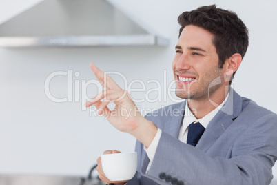 Businessman waving at someone in the kitchen