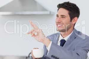 Businessman waving at someone in the kitchen