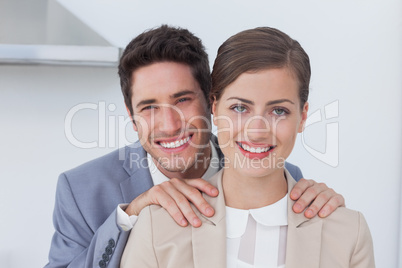 Couple of business people standing in their kitchen