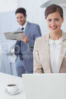 Businesswoman using a laptop before going to work