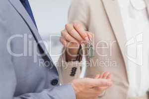 Real estate agent giving house key