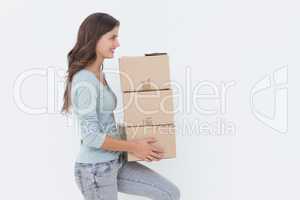 Woman holding boxes because she is moving in a new house