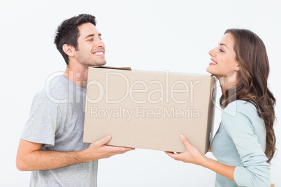 Cheerful woman and her husband holding a box