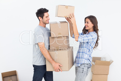 Woman giving boxes to her husband while they are moving