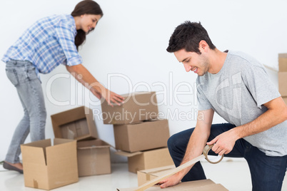 Woman and man wrapping boxes