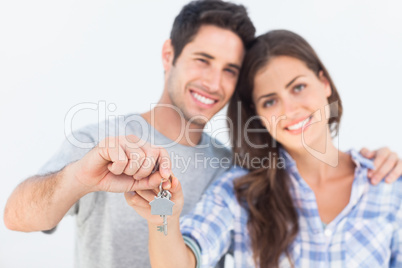 Man and wife holding a key with a house keychain