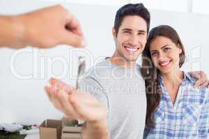 Happy man being given a house key
