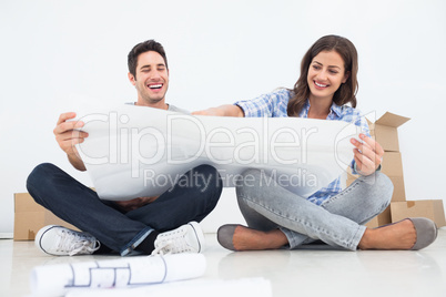 Man and his wife looking at their house plans