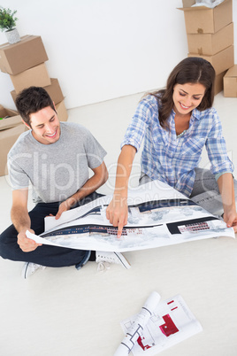Woman and her husband looking at their house plans