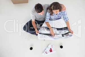 Overview of a husband and his wife looking at house plans